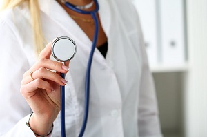 woman holding stethoscope up to camera